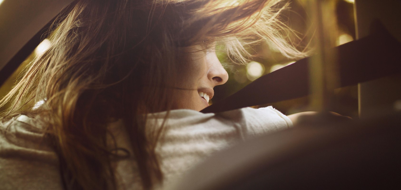 Rear view image of a woman's face with her hair blowing in the wind - SEAT Easy Mobility