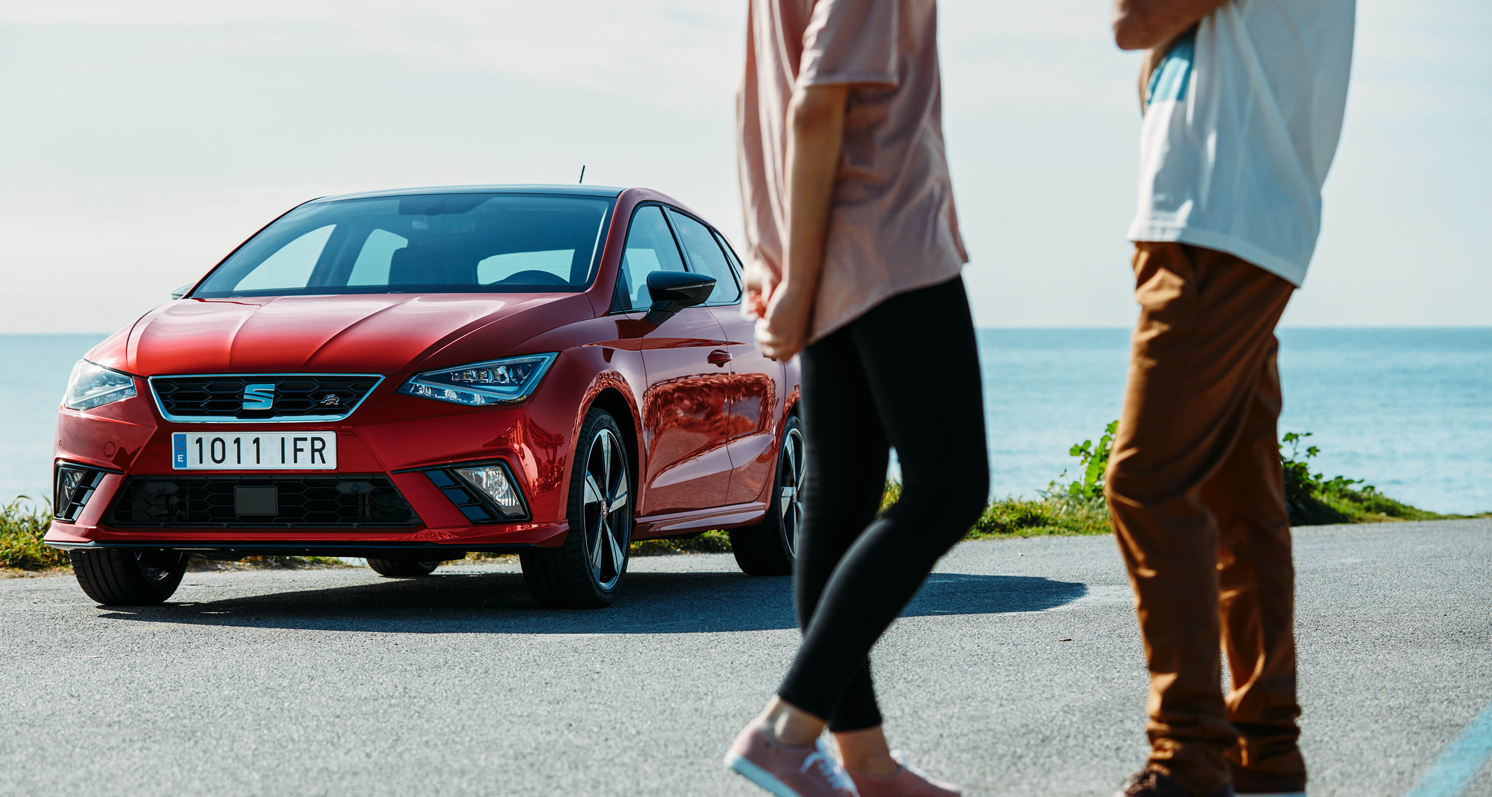 New desire red SEAT Ibiza front of the car by the sea