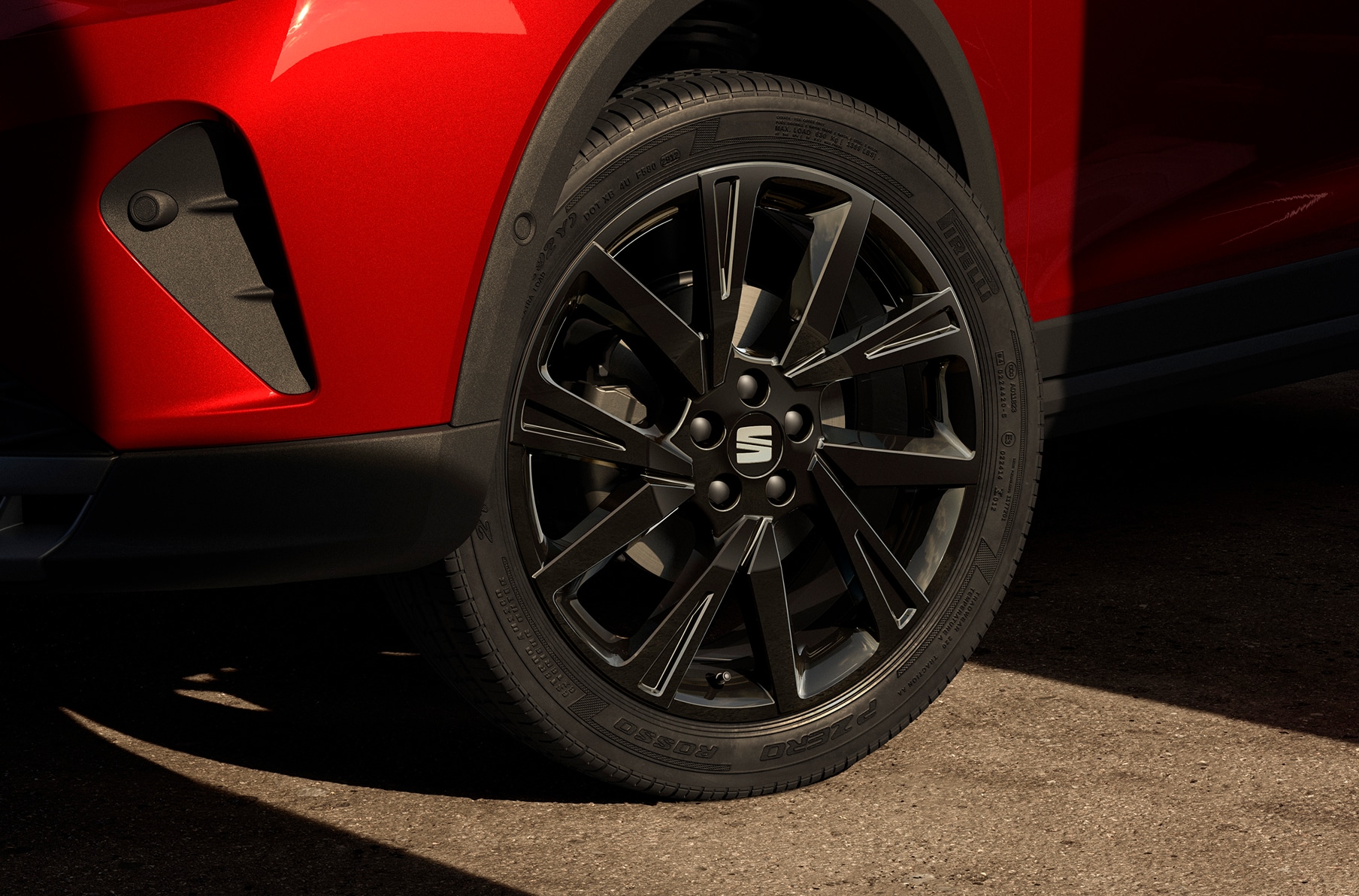 Seat arona fr in desire red, black edition 18 inch alloy wheel and front light close up vehicle.