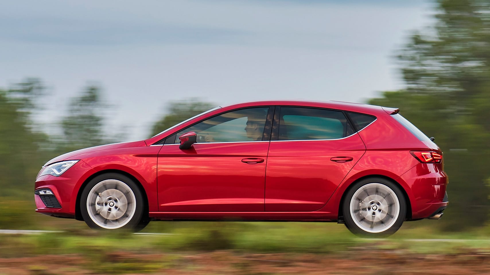 SEAT Ibiza driving outside forest landscape