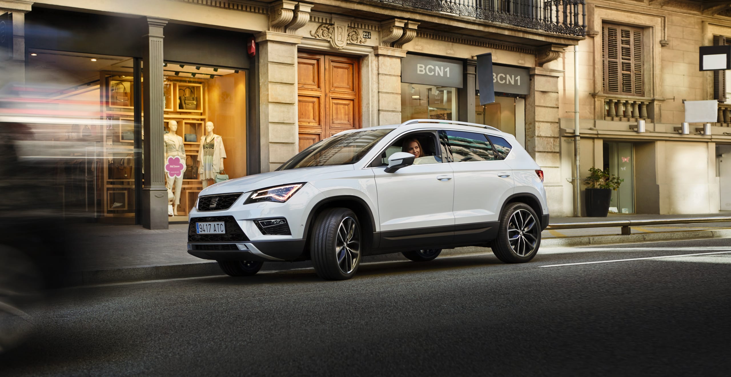 SEAT new car services maintenance insurance –  SEAT Ateca SUV side view driving on city street