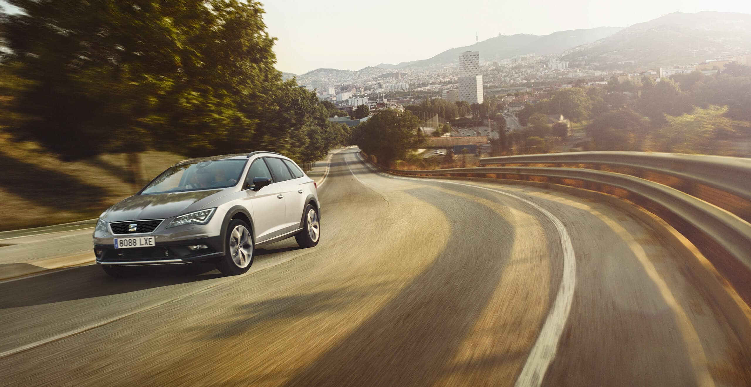 SEAT new car services and maintenance – Countryside view of a car driving at speed on an empty road