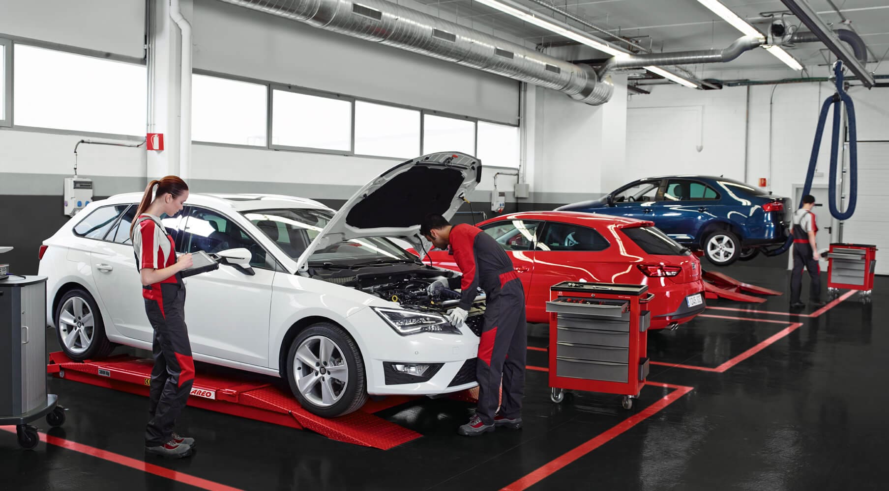 Car maintenance and servicing – SEAT mechanics inspecting a car in a garage